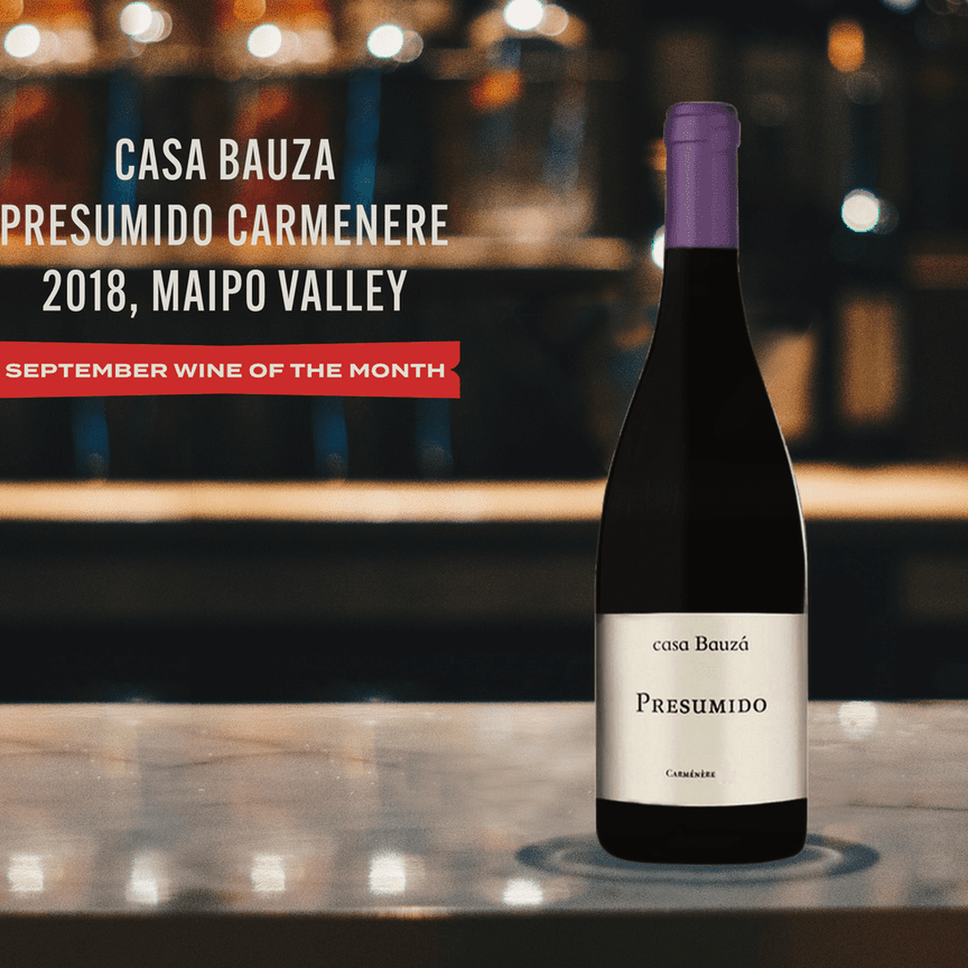 Promotional image of Casa Bauza Presumido Carmenere 2018 Maipo Valley bottle on marble countertop, with September Wine of the Month ribbon