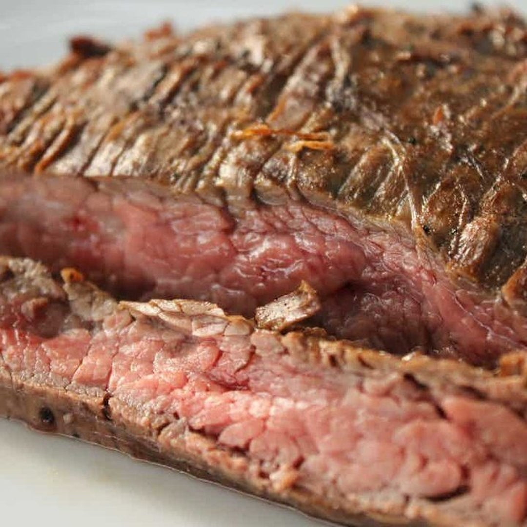 Sliced medium-rare steak close-up: seared exterior and pink, juicy interior