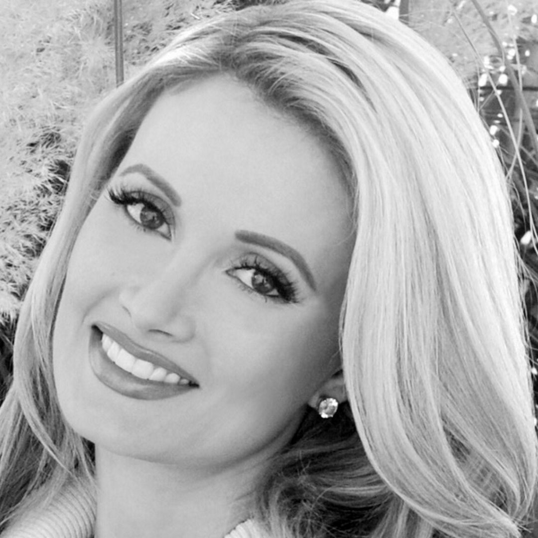 Close-up black-and-white portrait of Holly Madison wearing stud earrings, head tilted slightly.