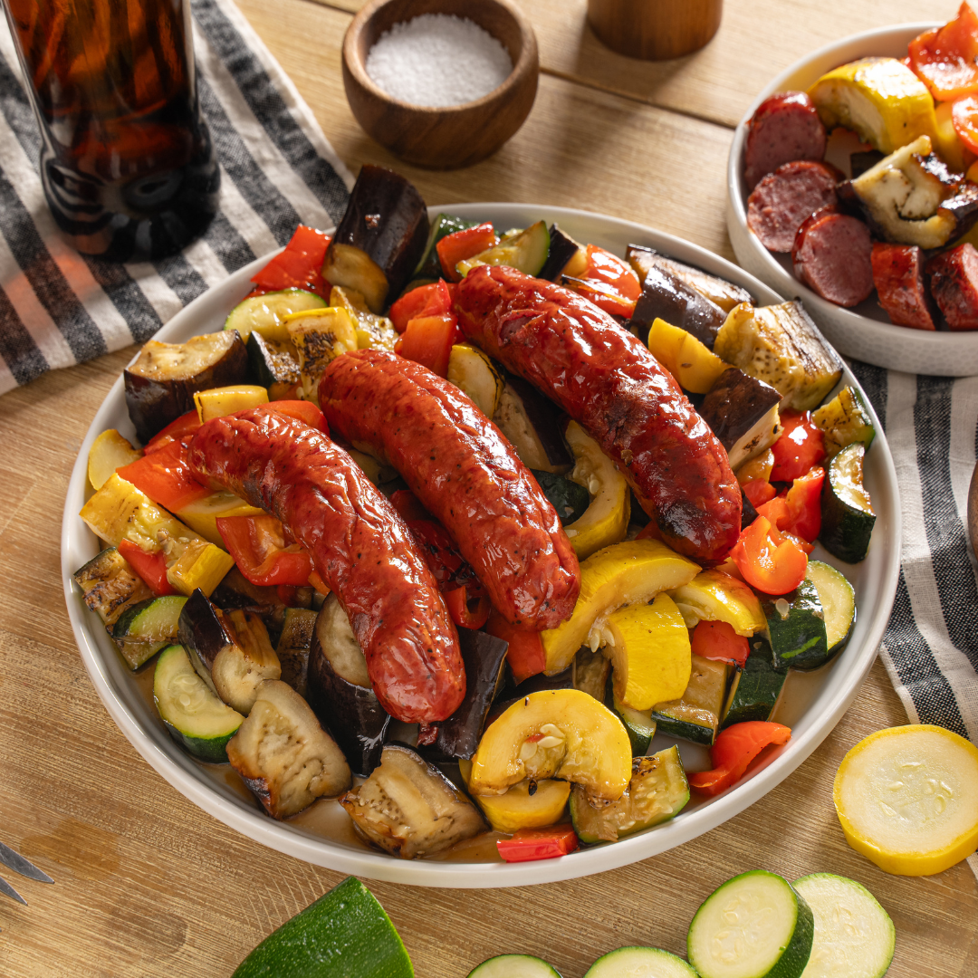 Roasted sausages with squash, zucchini, eggplant, and red peppers served on a platter