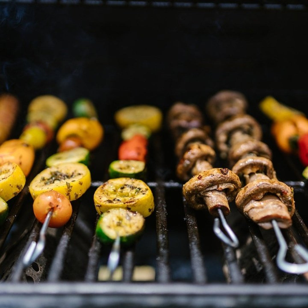 Colorful vegetable skewers grilling over a barbecue grill