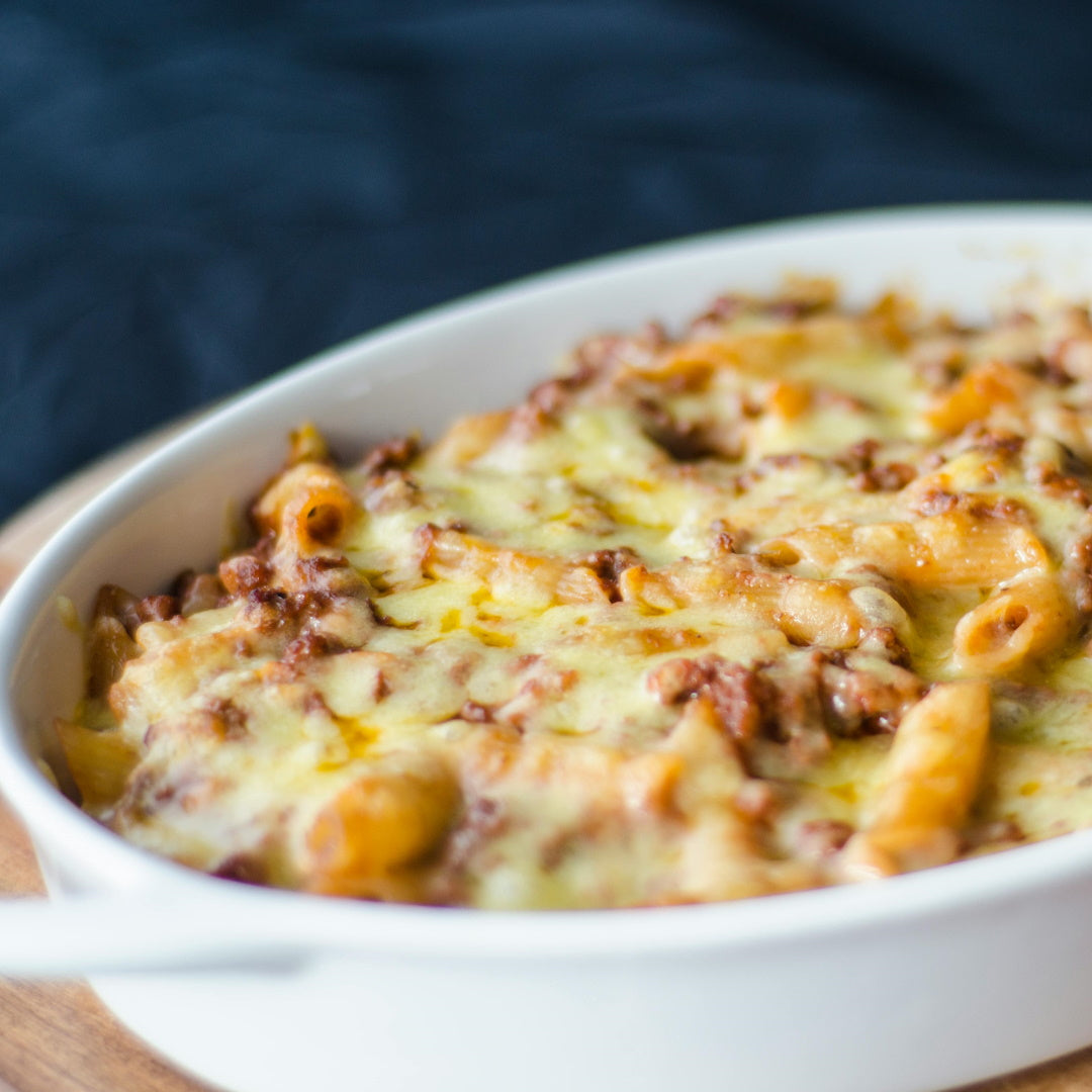 Creamy French onion mac and cheese baked in a white oval dish