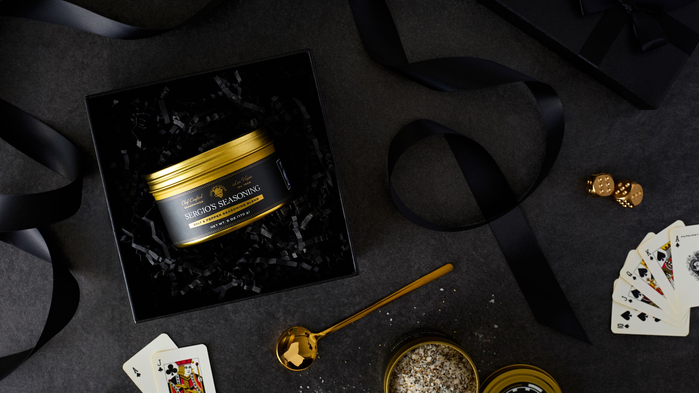 Gold-lidded tin reading 'SERGIO'S SEASONING Salt & Pepper Seasoning Blend NET WT. 6 OZ (170 g)' in black gift box
