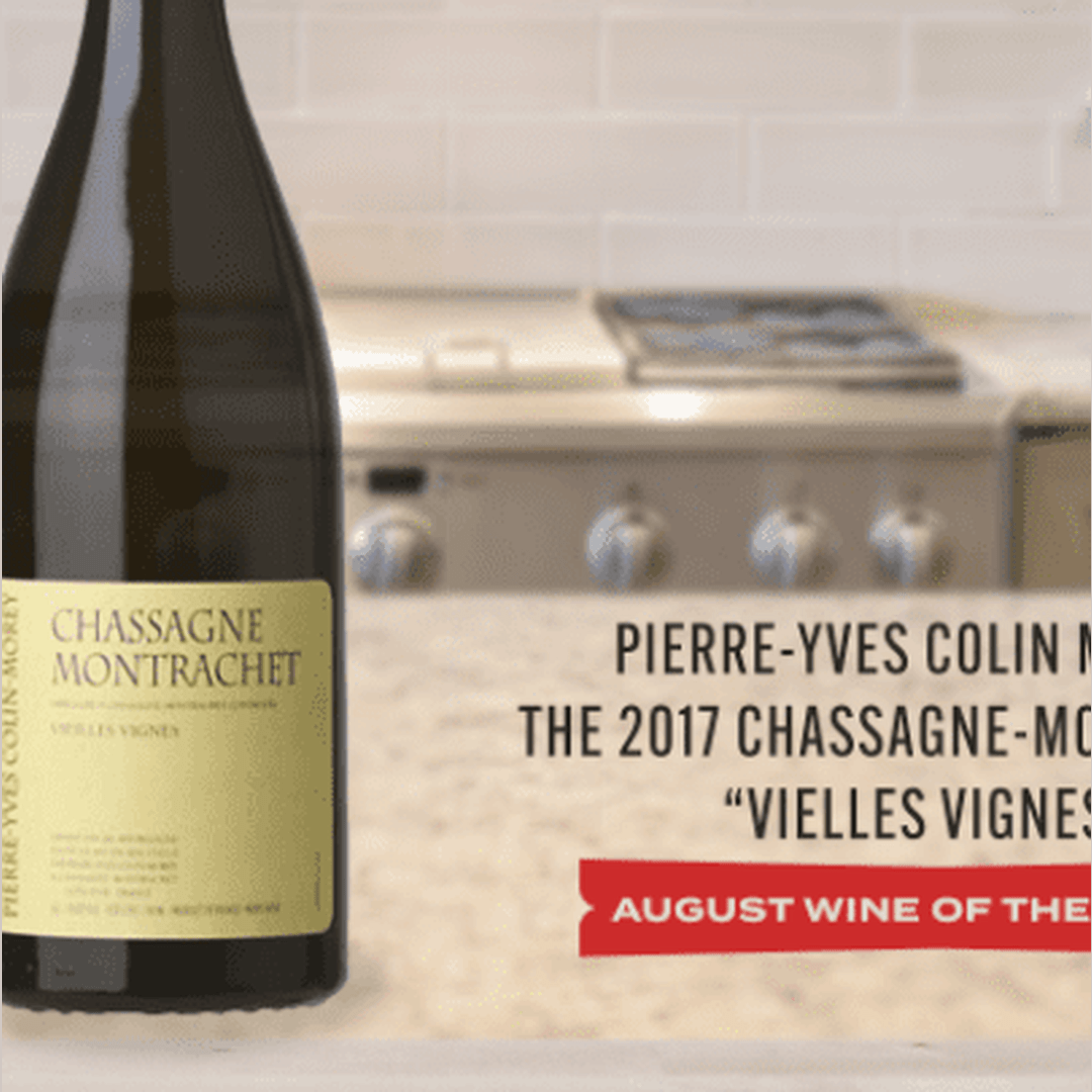 Pierre-Yves Colin 2017 Chassagne-Montrachet Vieilles Vignes bottle with overlaid headline August Wine of the on kitchen counter