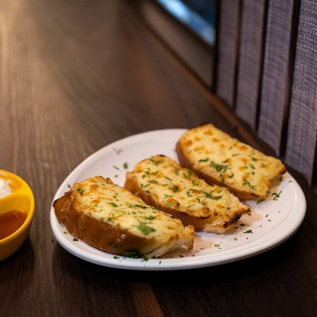 Three slices of cheesy garlic bread garnished with parsley on a white plate