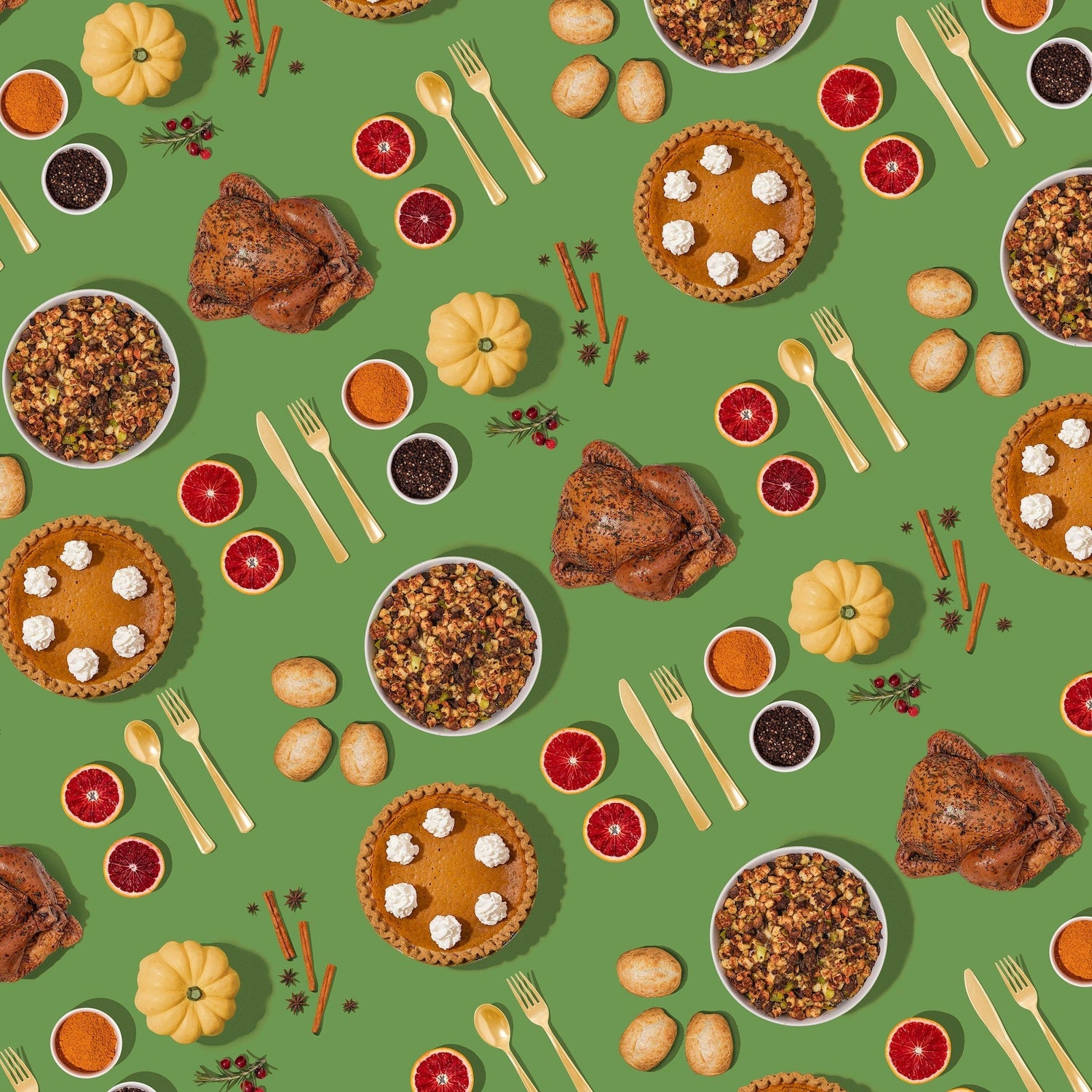 Patterned flatlay of Thanksgiving foods: roast turkey, pumpkin pie, stuffing, rolls and citrus slices on green.
