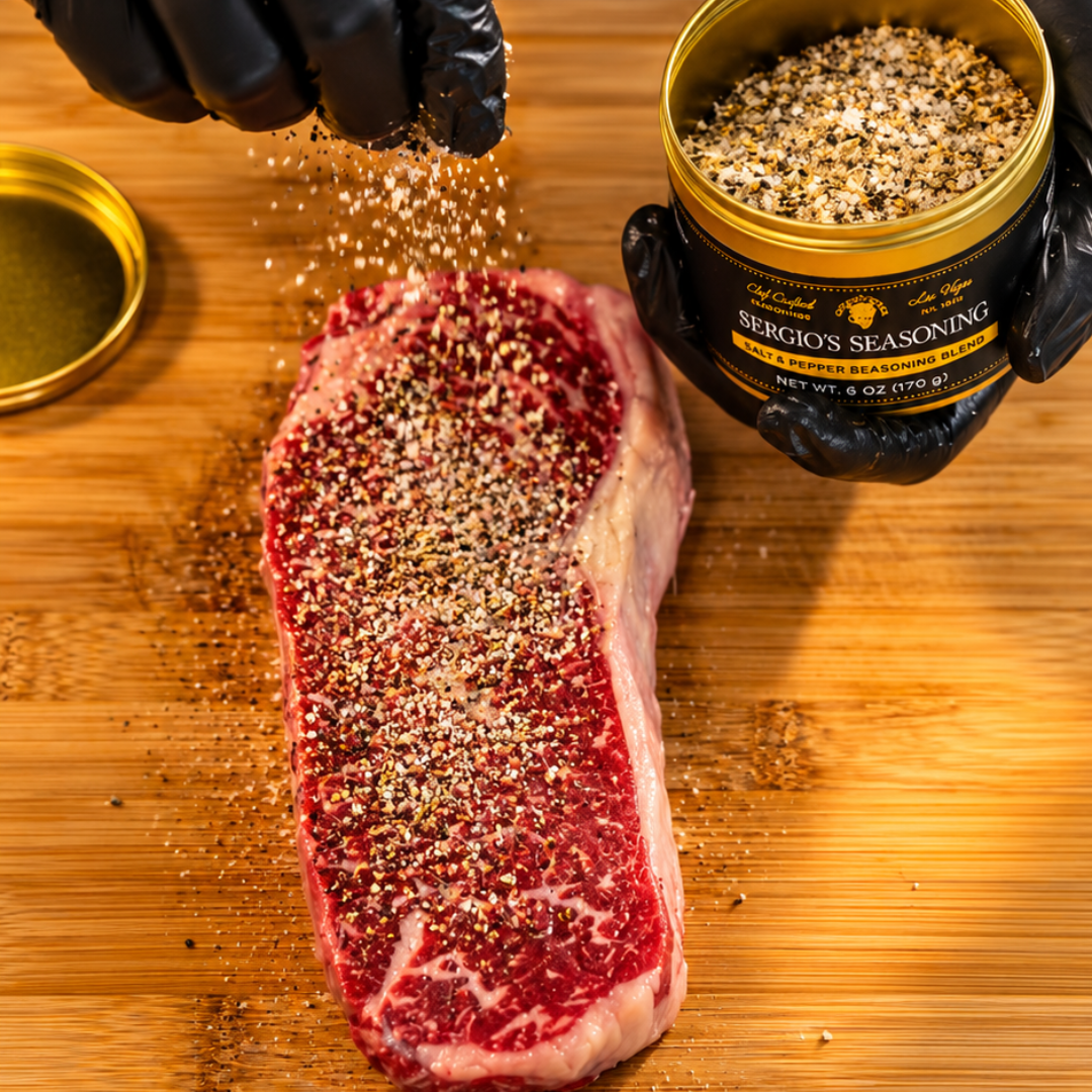 Gloved hands season a raw Wagyu New York strip on a wooden cutting board with Sergio’s Seasoning
