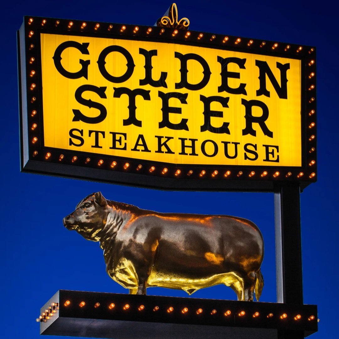 Golden Steer Steakhouse logo on fluorescent blue background