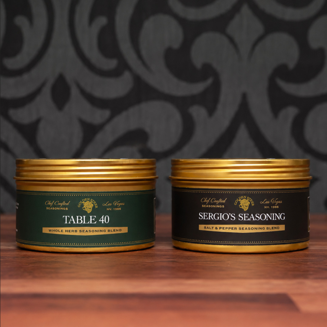 Front view of The Bread Oil Duo showcasing Table 40 and Sergio’s Seasoning tins on a wooden table